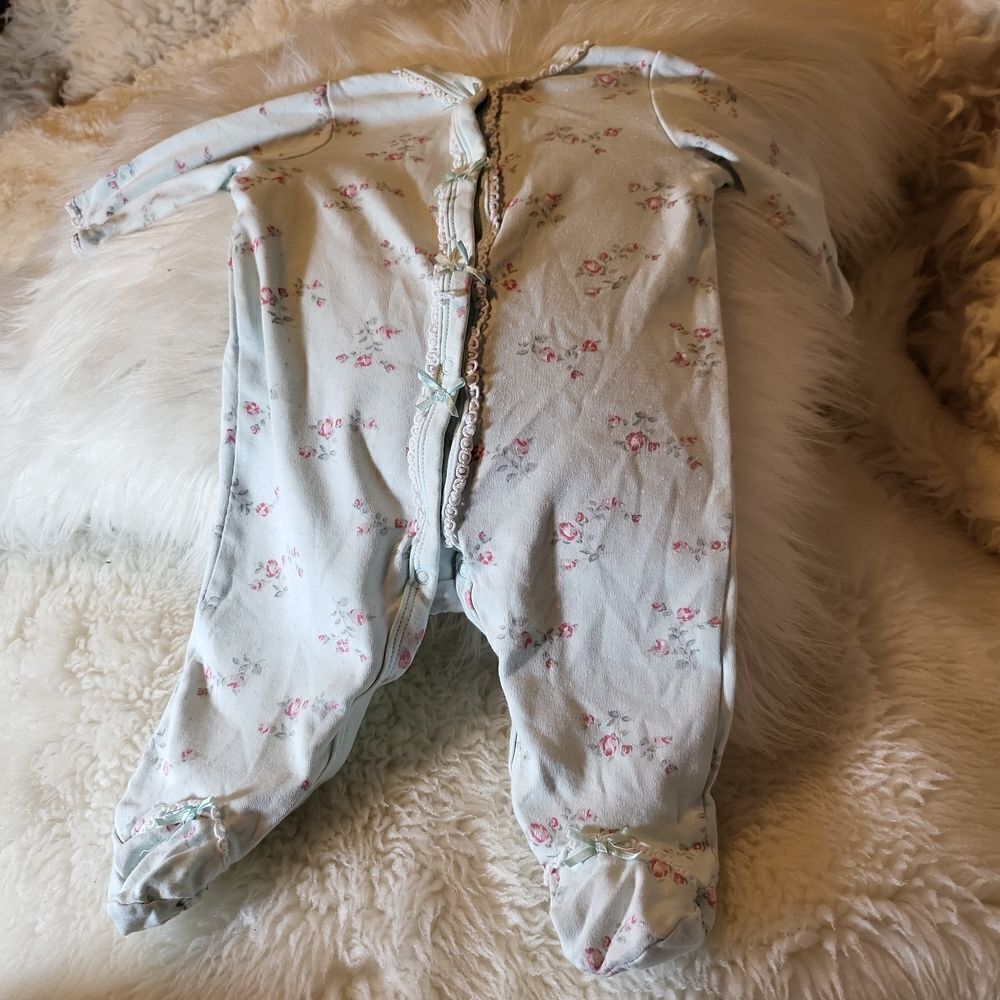 A onsie forย a 3 month old by little me, has flowers all over it, soft andโpretty